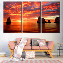 Load image into Gallery viewer, Ocean Sunset Canvas Wall Art Ocean Rocks Boulders  3 Piece Canvas Print Dramatic Orange Blue Cloudy Sky Multi Panel Canvas In Living Room
