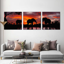 Load image into Gallery viewer, elephants  family  canvas  wall  art  black  group  elephant  3  piece  canvas  print  elephant  in  orange  nature  multiple  canvas In Living Room
