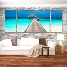 Load image into Gallery viewer, pier to the overwater bungalows maldives ocean blue sky 3 piece canvas prints In Living Room
